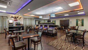 A hotel lobby with multiple seating areas, a coffee station, and a reception desk. - Best Western Plus North Odessa Inn & Suites (Odessa)