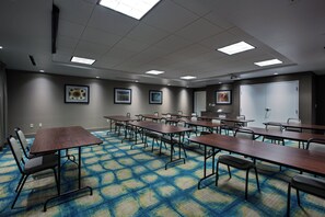 A conference room with multiple tables and chairs, a patterned carpet, and framed artwork on the walls. - Holiday Inn Express Hotel & Suites, Carlisle-Harrisburg Area by IHG (Carlisle)