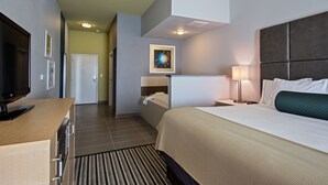 A hotel room with a bed, bedside table, lamp, TV, and a painting on the wall. - Holiday Inn Express Hotel & Suites, Carlisle-Harrisburg Area by IHG (Carlisle)