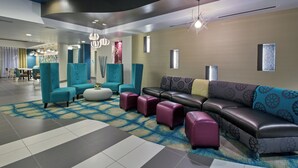 A modern lobby with seating areas, a patterned carpet, and contemporary lighting fixtures. - Holiday Inn Express Hotel & Suites, Carlisle-Harrisburg Area by IHG (Carlisle)