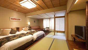 A hotel room with two beds, a television, tatami mats, a window with curtains, and a wooden ceiling.