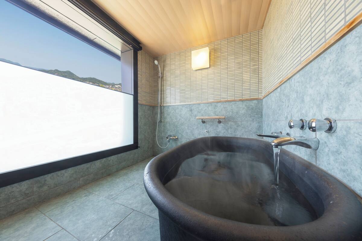 corner suite-sansoka with open-air bath (non-smoking) | bathroom | combined shower/bathtub, deep-soaking bathtub, rainfall showerhead