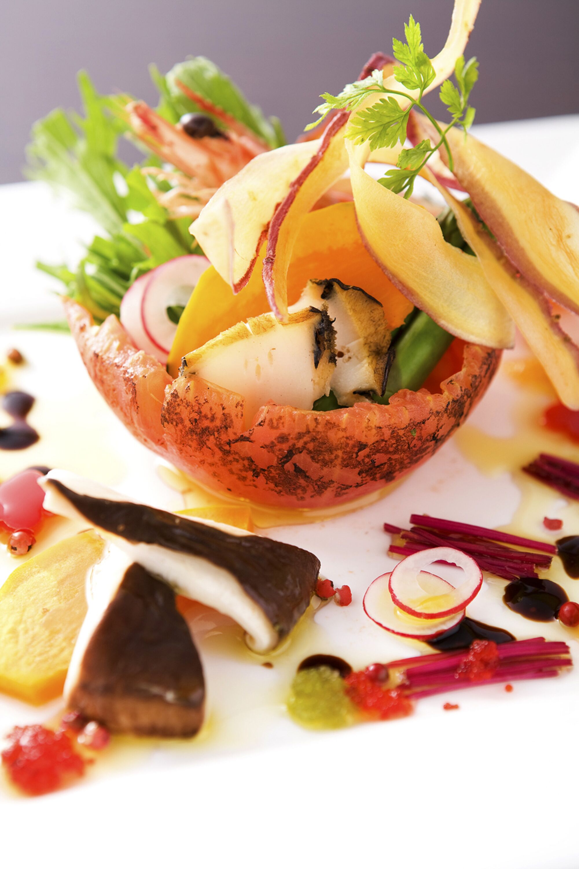 A seafood dish with various garnishes and sauces.
