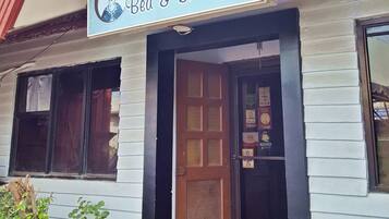 A building with a sign for "Lola Itang Pension and Restaurant Bed & Breakfast".