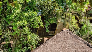 A pool with a thatched-roof structure, surrounded by lush greenery. - Ponta do Madeiro (Tibau do Sul)