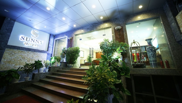 A hotel entrance with a sign reading "SUNNY HOTEL," steps leading up to the entrance, and potted plants around the area. - Sunny 3 Hotel Hanoi (Hanoi)
