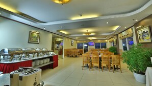 A dining area with buffet stations, wooden chairs, and a ceiling with recessed lighting. - Sunny 3 Hotel Hanoi (Hanoi)