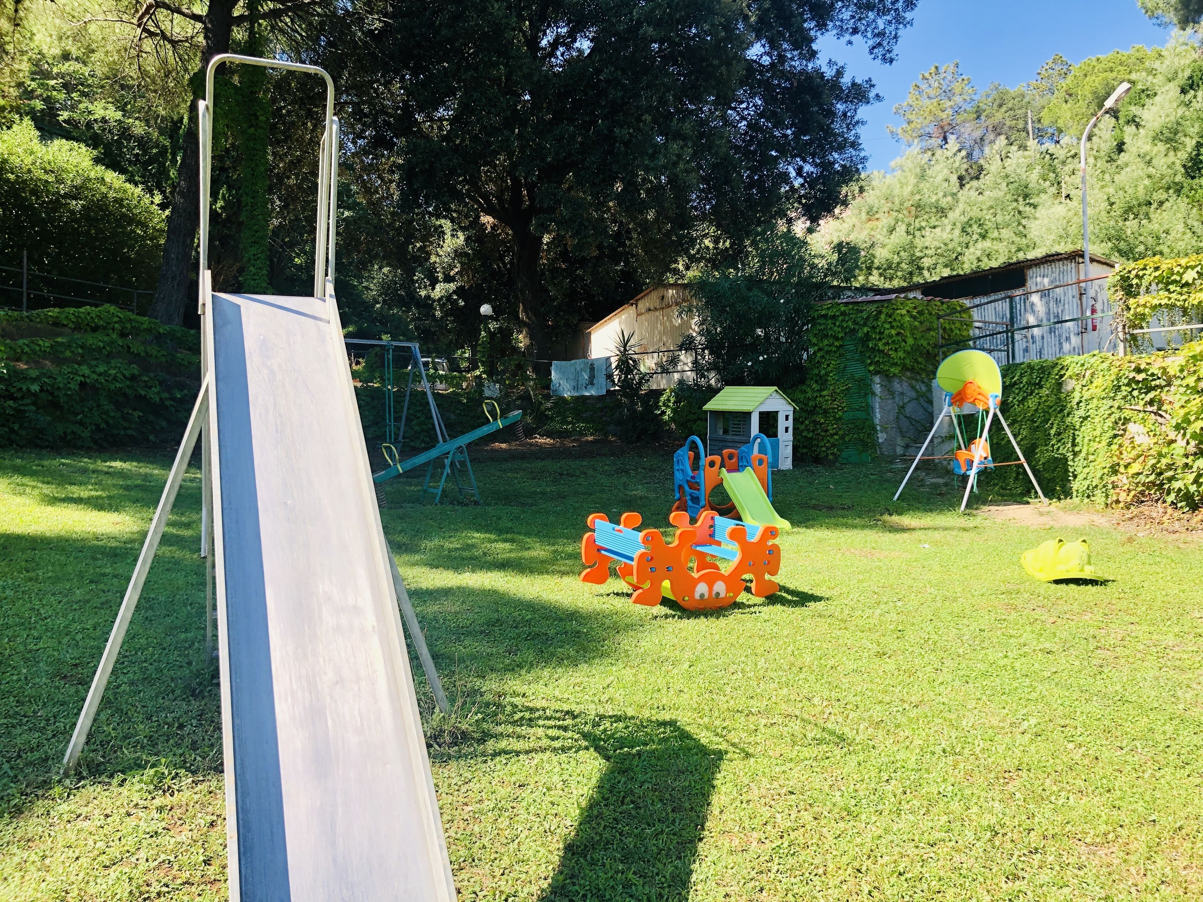 A playground with a slide, swings, and a climbing structure.