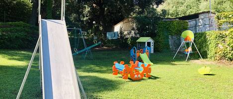 A playground with a slide, swings, and a climbing structure.