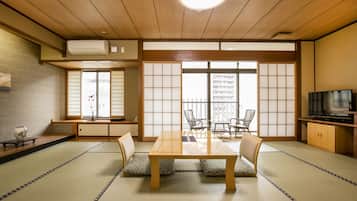 A traditional Japanese room with tatami flooring, a low table, and shoji screens.
