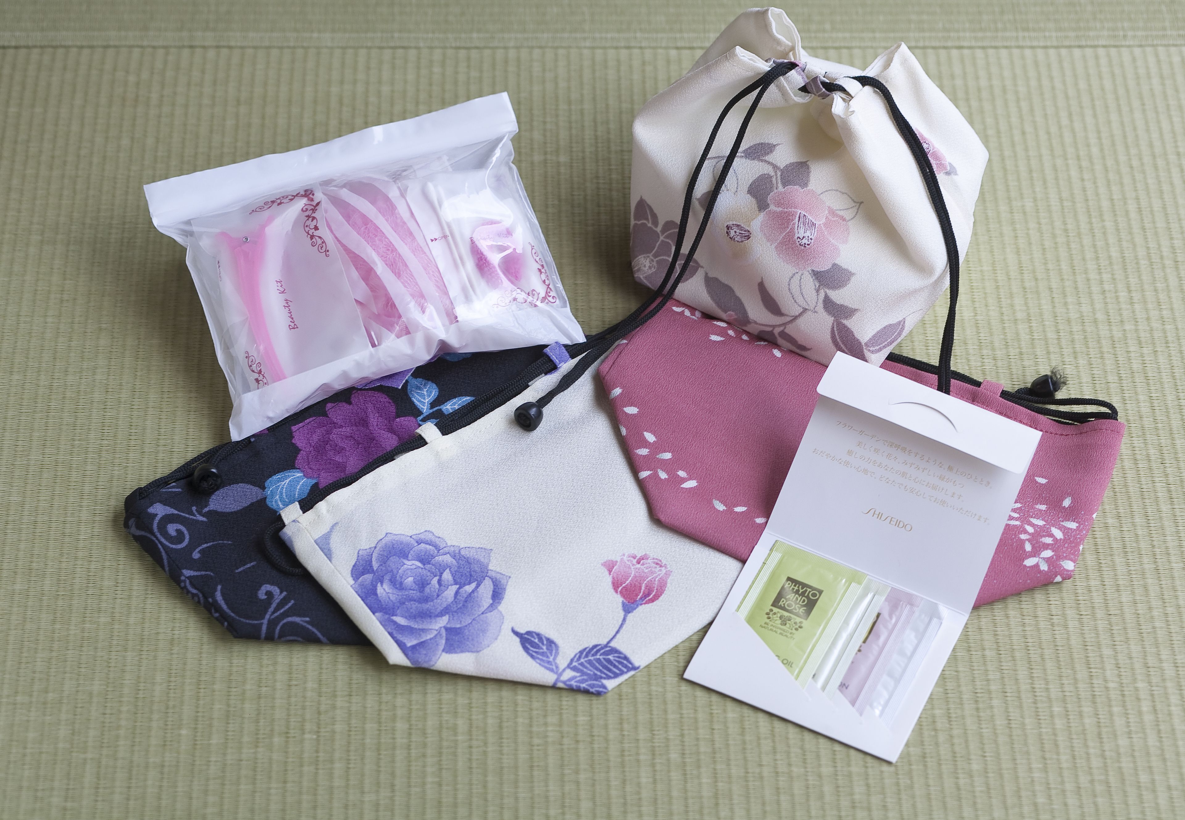 A set of drawstring bags with floral patterns and a card with text.