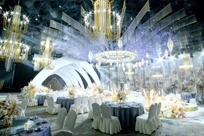 A formal event space with round tables, chairs, and elaborate chandeliers. - Yulin Hotel (Yulin)