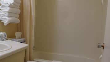 A bathroom with a toilet, sink, and bathtub.