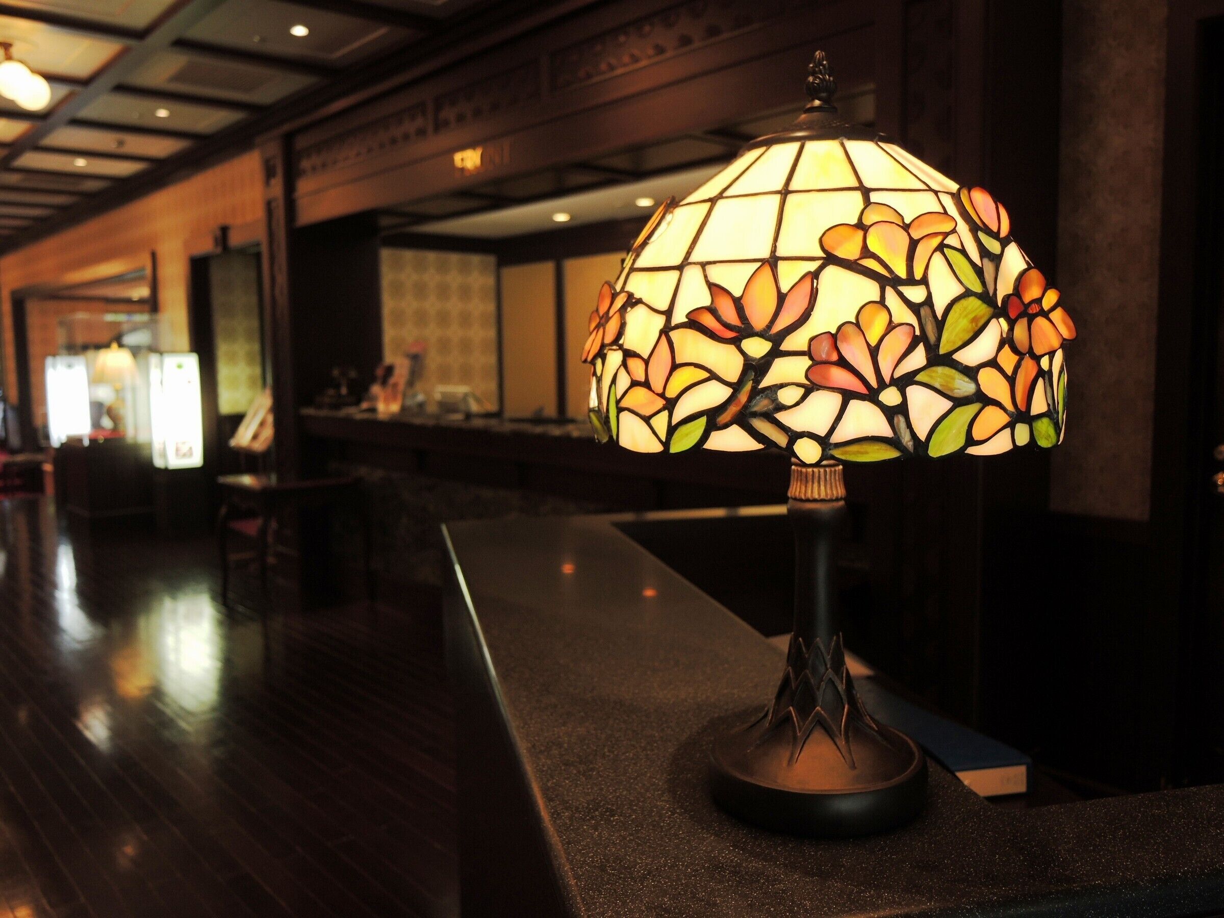 A lobby with a decorative lamp on a counter.