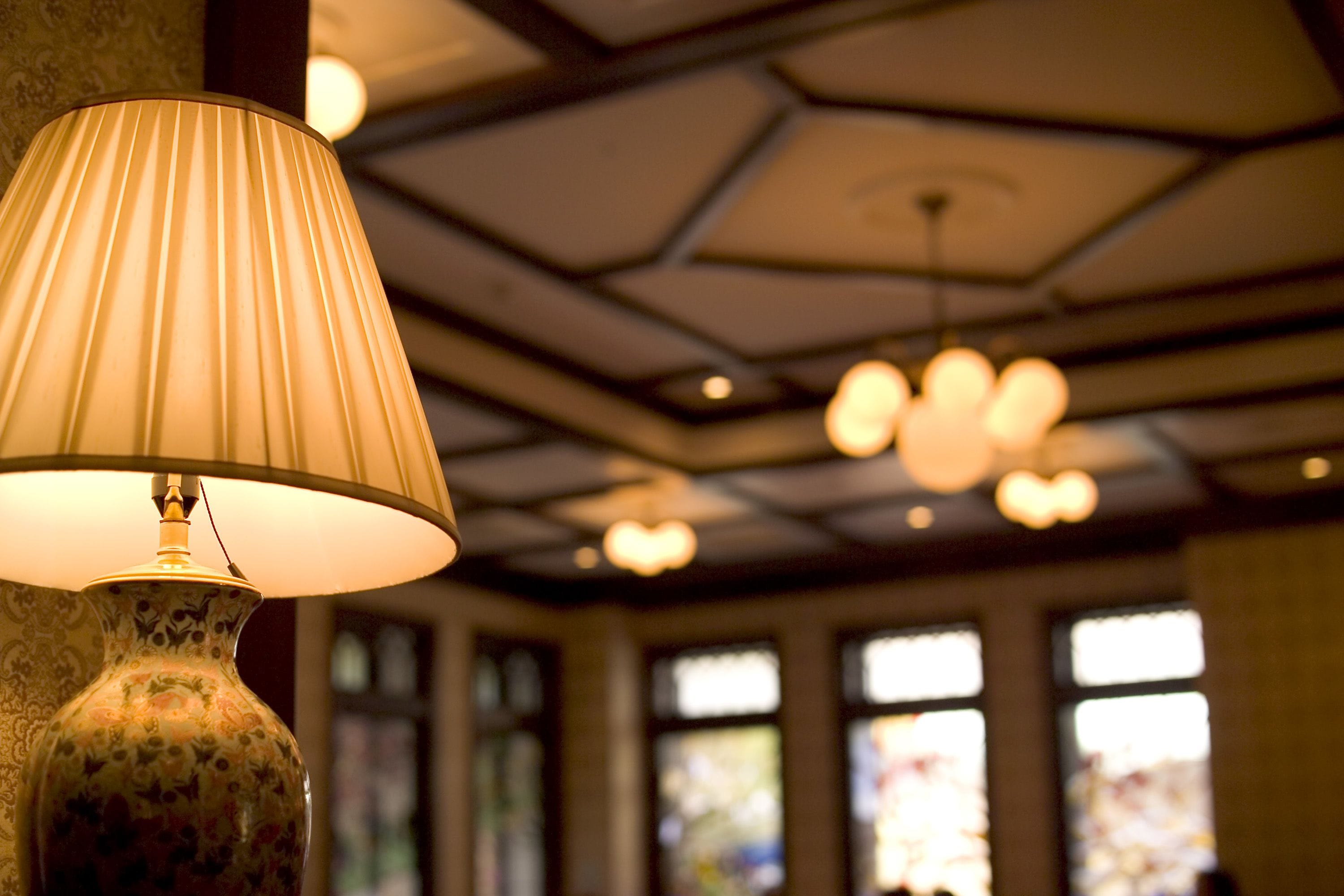 A lamp with a ribbed shade and a decorative vase.