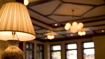 A lamp with a ribbed shade and a decorative vase.