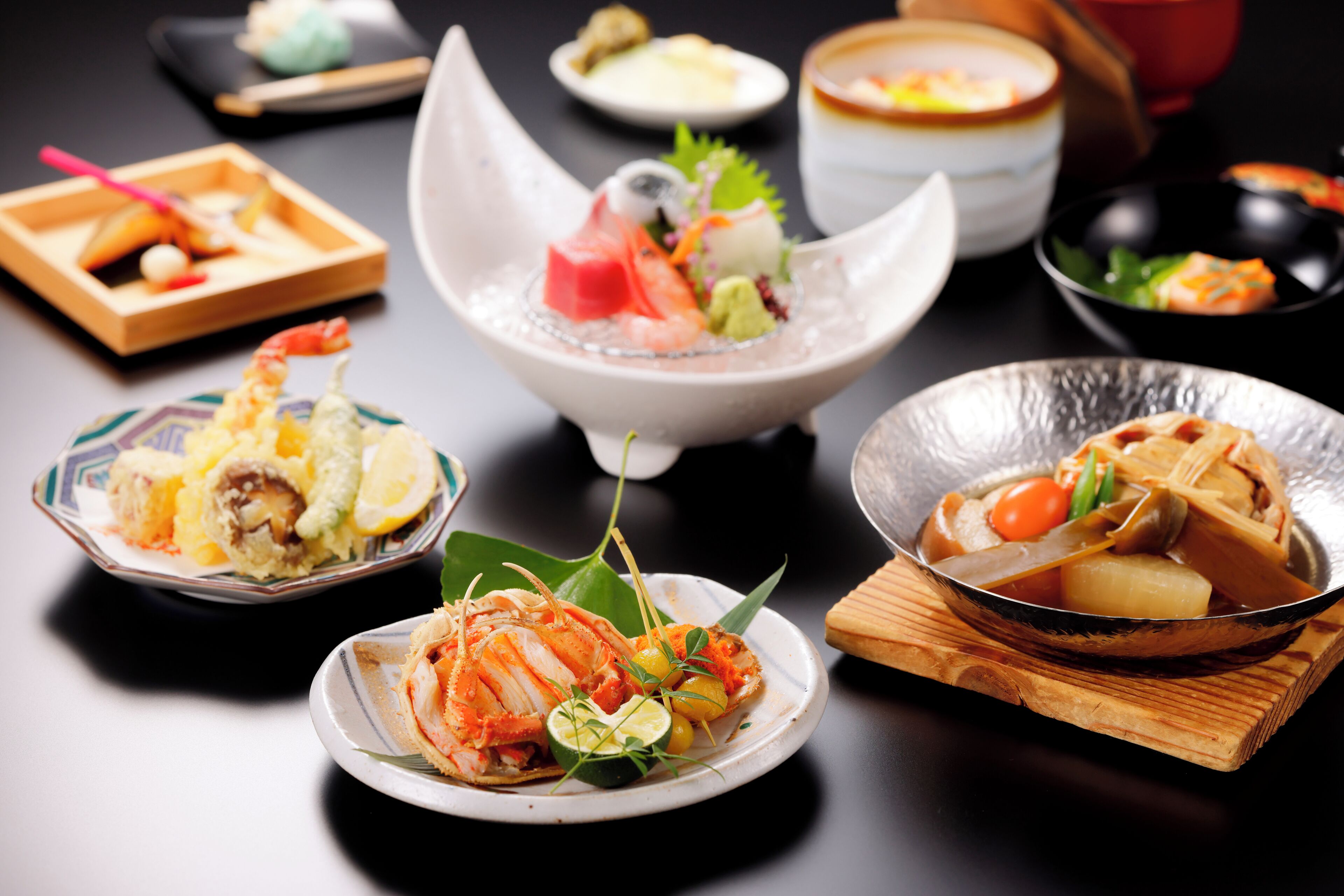 A variety of dishes on a table, including seafood and vegetables.