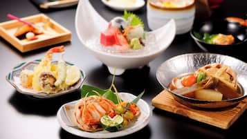 A variety of dishes on a table, including seafood and vegetables.
