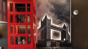 A red telephone booth with a view of the Tower Bridge. - The Happy Traveler (Groningen)