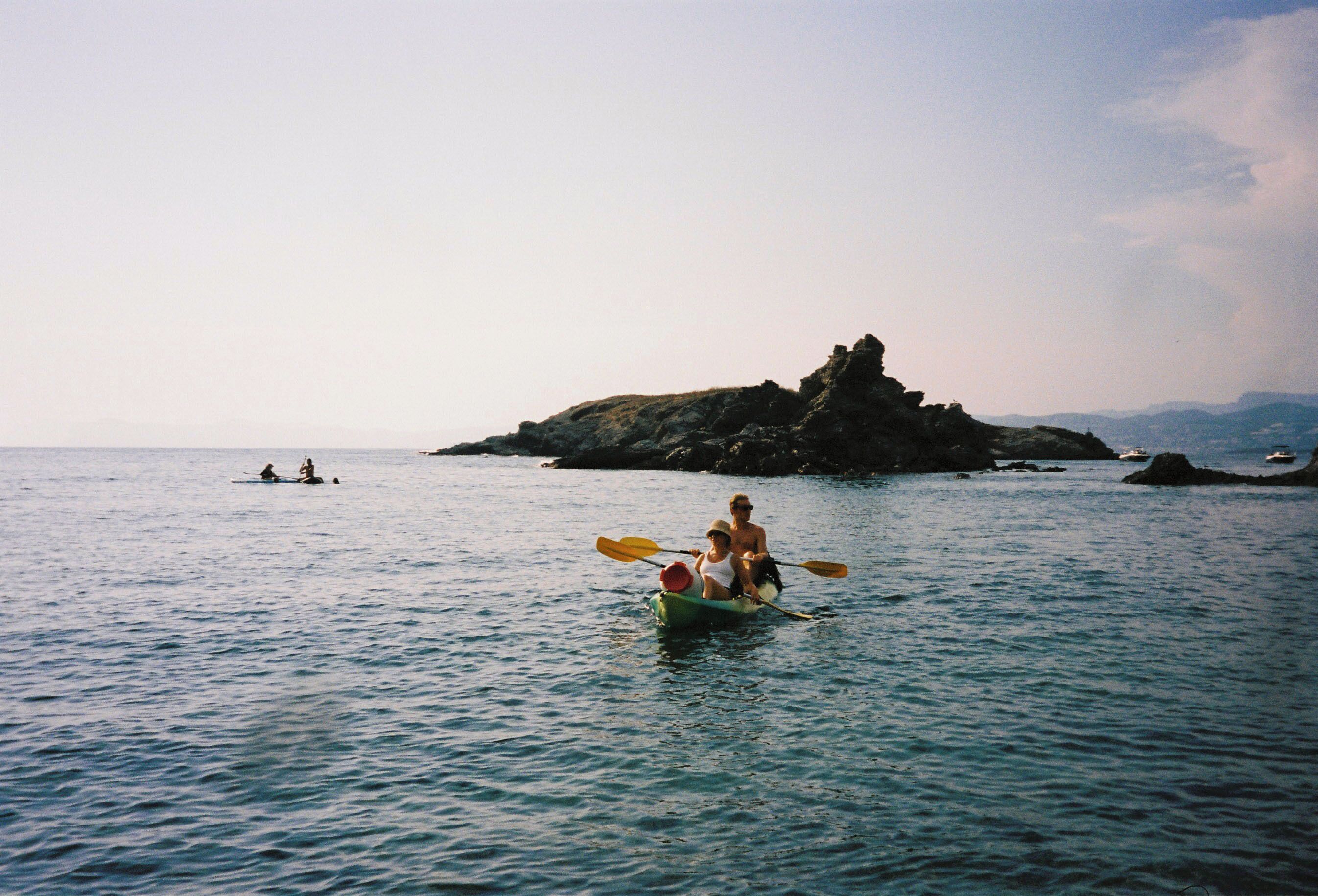 A calm body of water with a small island in the distance.