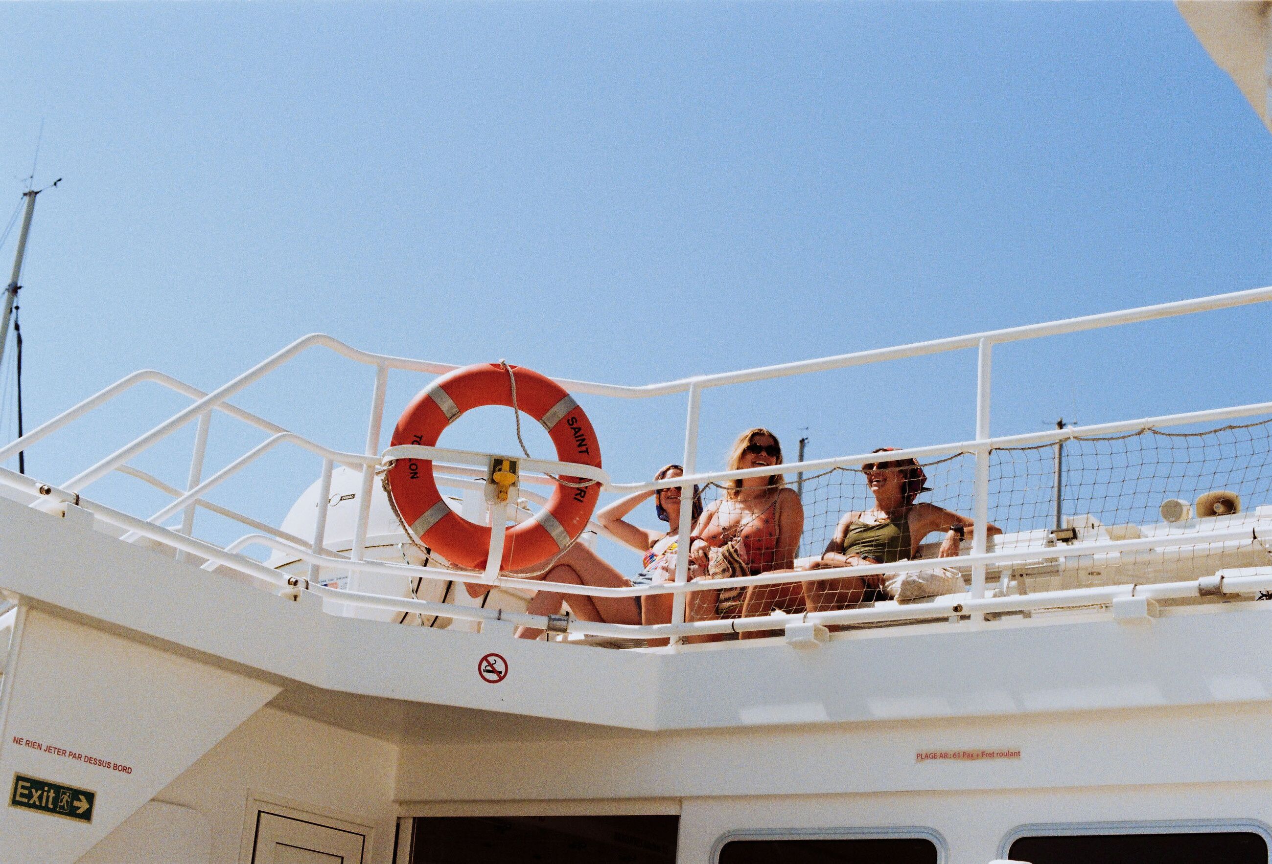 A lifeboat with a life ring and a sign indicating an exit.