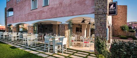 A building with outdoor seating and a stone facade.