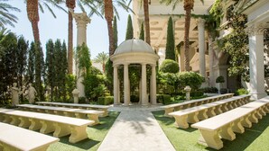 A garden with a central pavilion, surrounded by benches and palm trees. - NOBU Las Vegas – A Caesars Rewards Destination (Las Vegas)