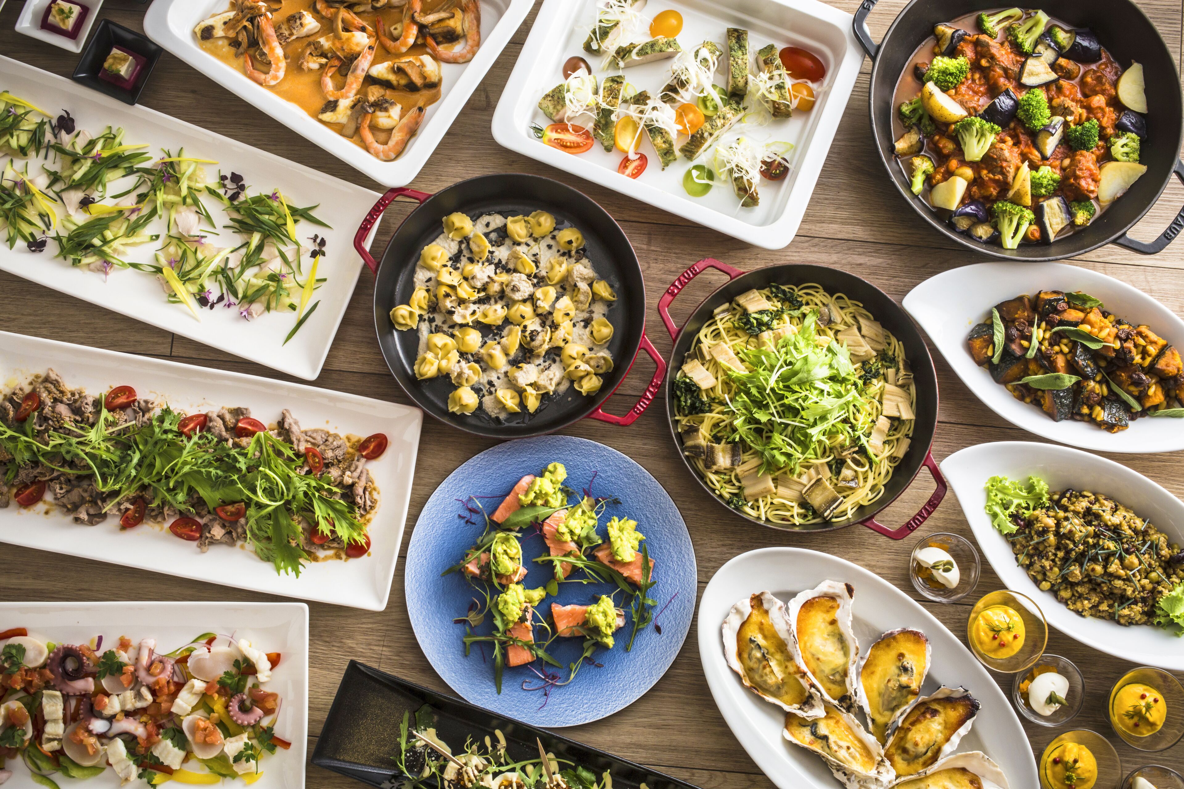 A variety of dishes on a wooden table.