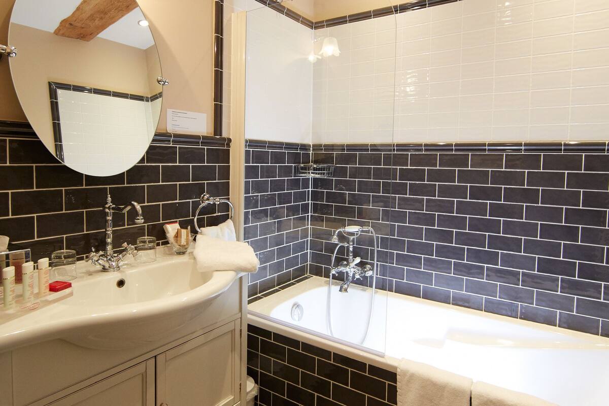 comfort room | bathroom | designer toiletries, hair dryer, slippers, towels