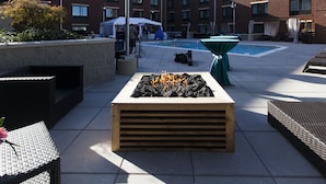 A rooftop patio with a fire feature, outdoor seating, and a swimming pool. - Hampton Inn & Suites Chapel Hill-Carrboro/Downtown (Carrboro)