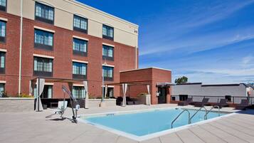Una piscina al aire libre, tumbonas