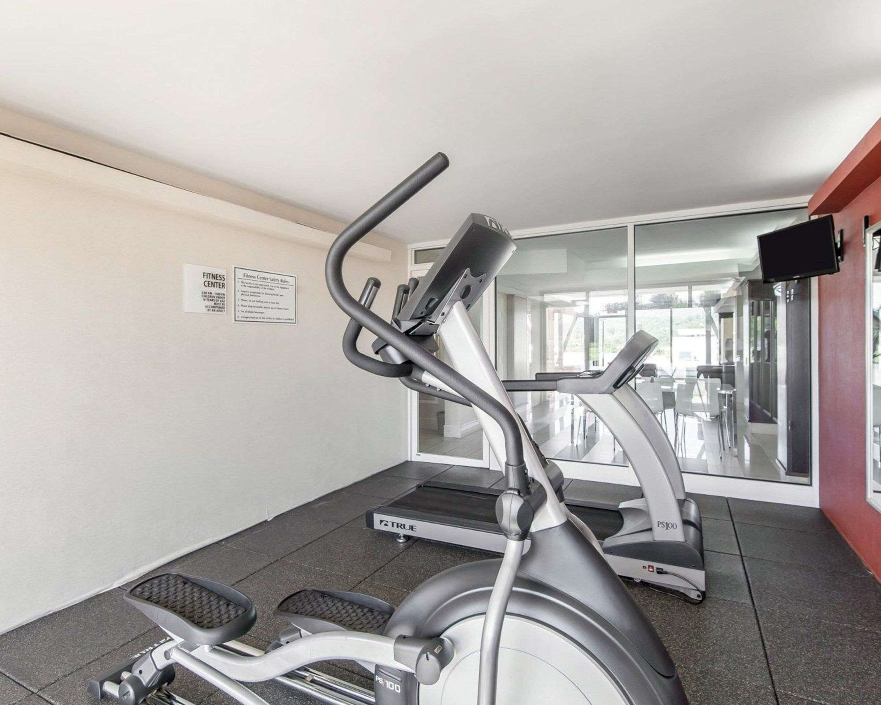 A fitness center with treadmills and an elliptical machine.