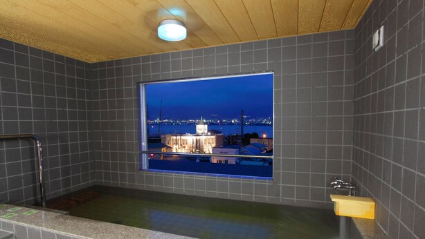 A modern bathroom with a large window, a bathtub, and a shower area. - Hakodate Motomachi Hotel (Hakodate)