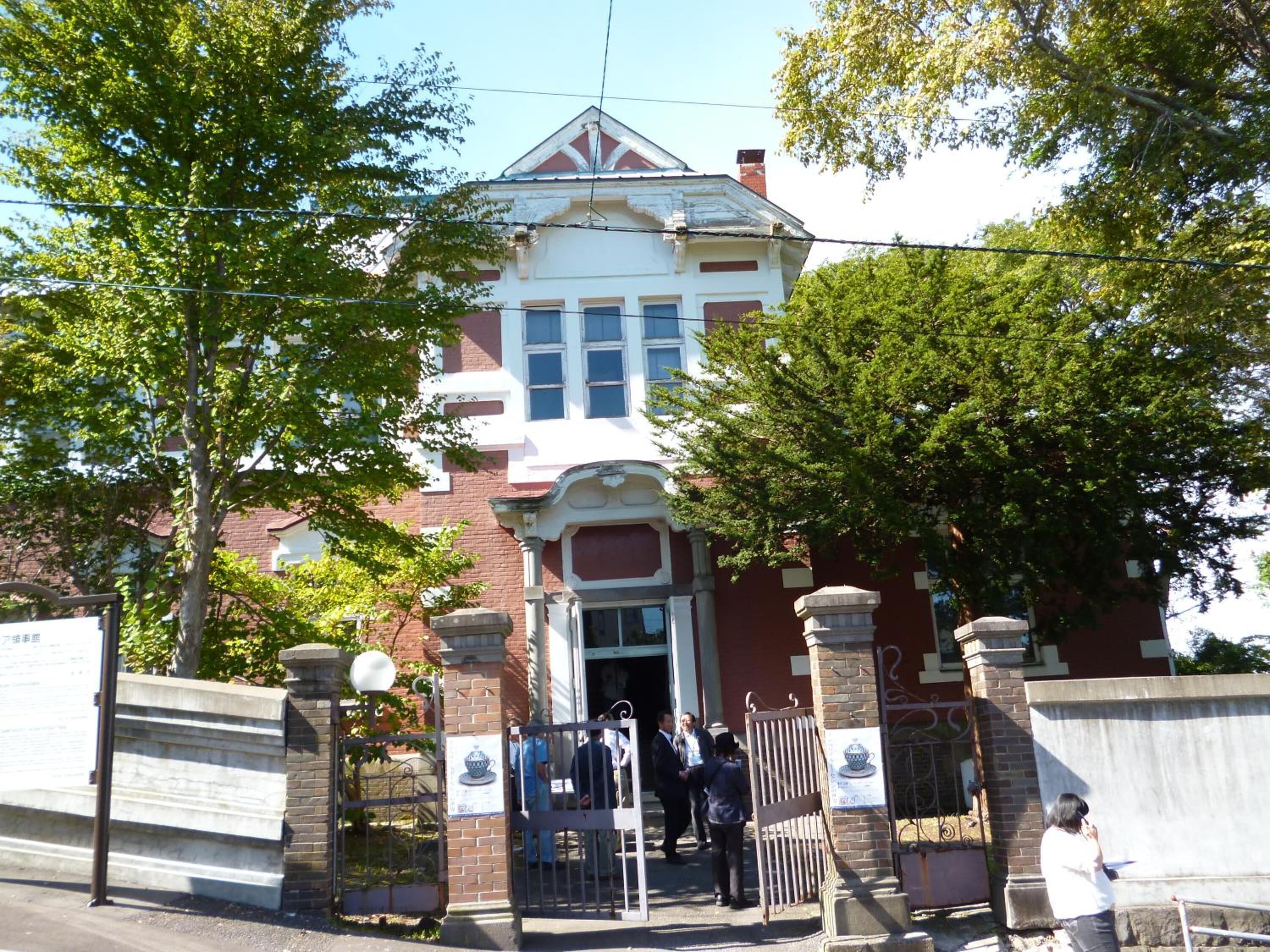 A historic building with a prominent entrance, large windows, and a traditional architectural style.