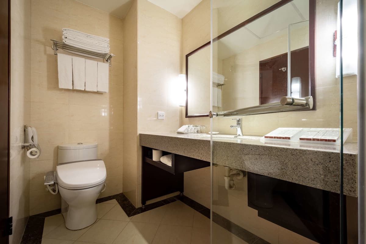 classic room, 2 queen beds-parking available | bathroom | hair dryer, slippers, bidet, towels