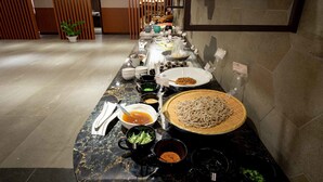 A buffet setup with various dishes and condiments on a marble counter. - CHECK Inn Taichung LaiLai (Taichung)
