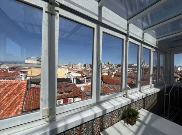 A high-rise building with large windows offering a view of the cityscape.