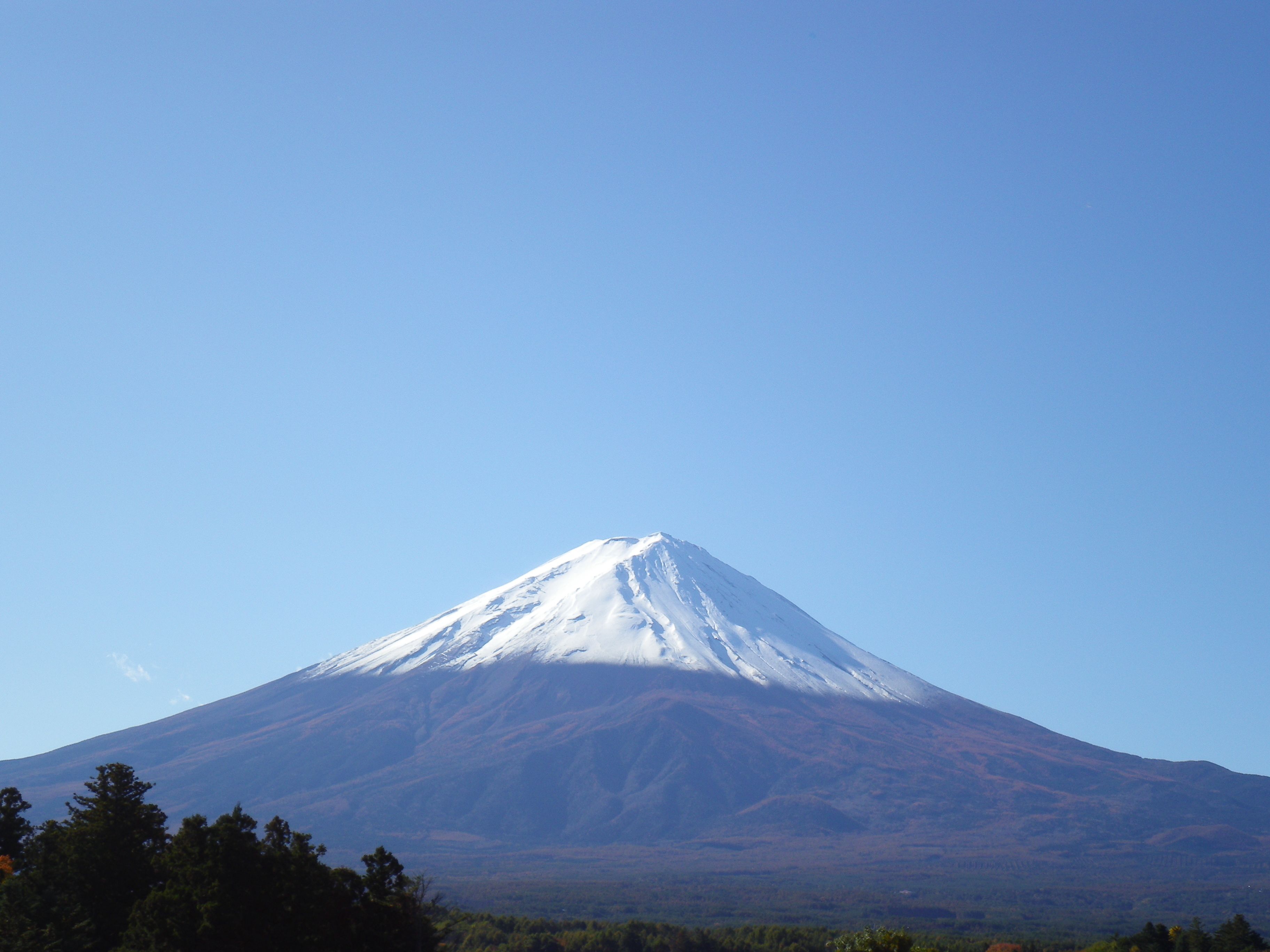 A snow-capped mountain under a clear sky.