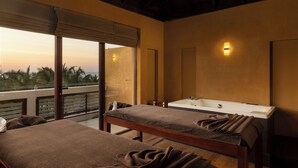 A room with two beds, a large window, a bathtub, and a view of palm trees.