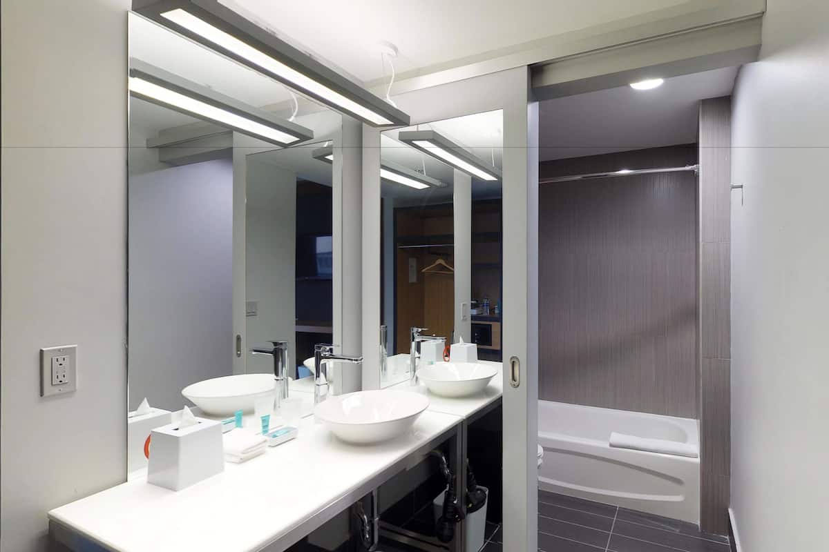 Separate tub and shower, rainfall showerhead, designer toiletries