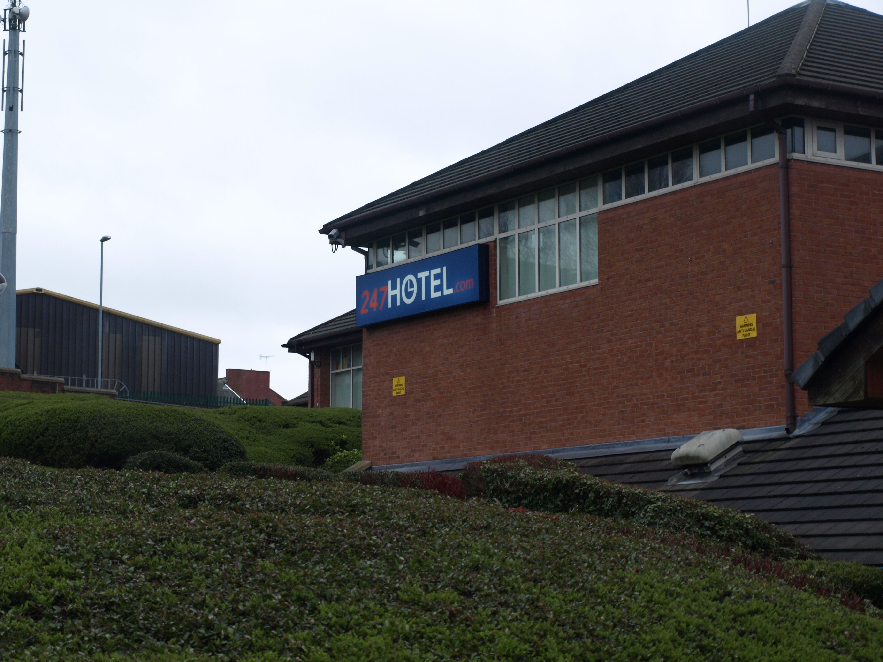 A hotel with a sign reading "247 HOTEL".