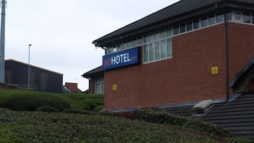 A hotel with a sign reading "247 HOTEL".