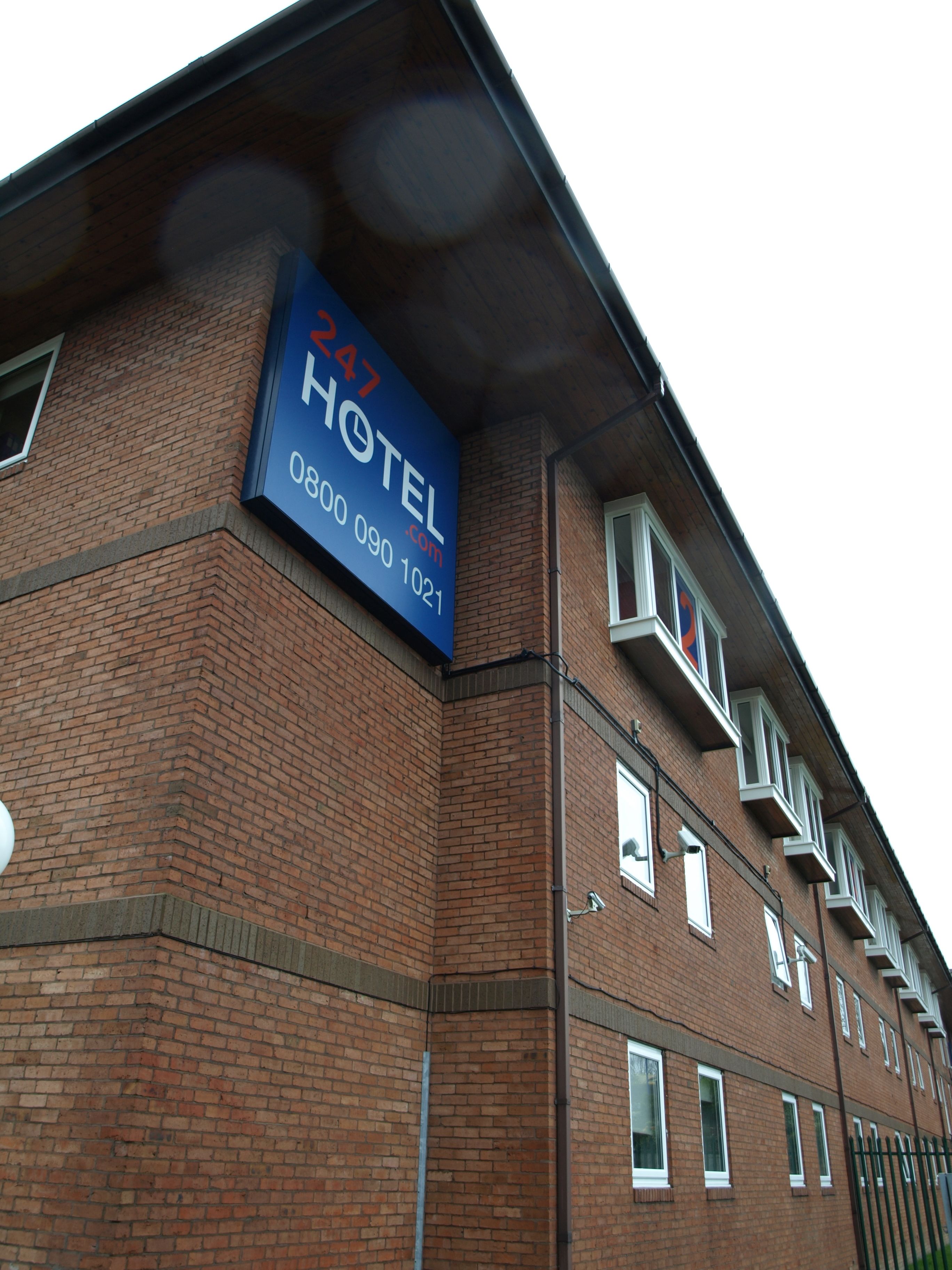 A hotel sign with the number 247 and contact information.