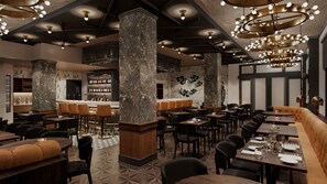 Interior de restaurante con techos altos, paredes de ladrillo visto y una zona de bar.