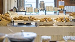 A buffet table with various food items and condiments. - Kymi Palace Hotel (Kymi-Aliveri)