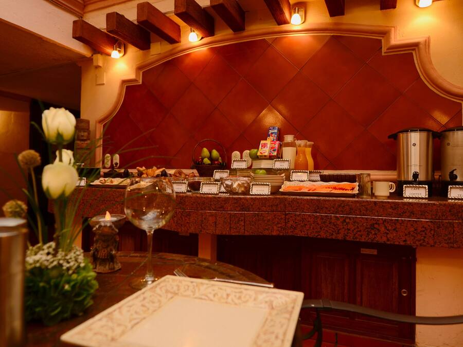 A restaurant counter with a variety of food items and a coffee machine.
