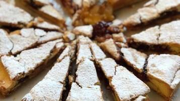 A round dessert with triangular slices on a white plate.
