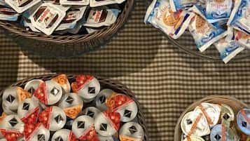 Three baskets filled with packaged food items, likely for a gathering or event.