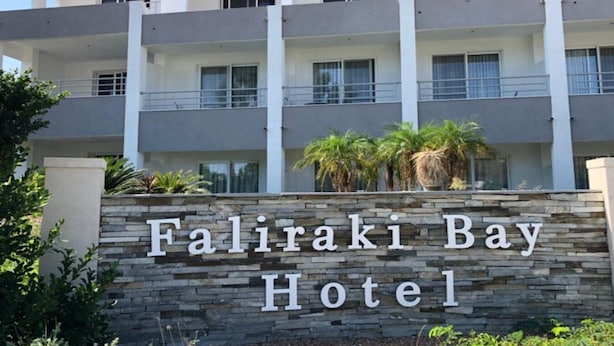 A multi-story hotel with a stone facade and balconies. - Faliraki Bay (Rhodes)
