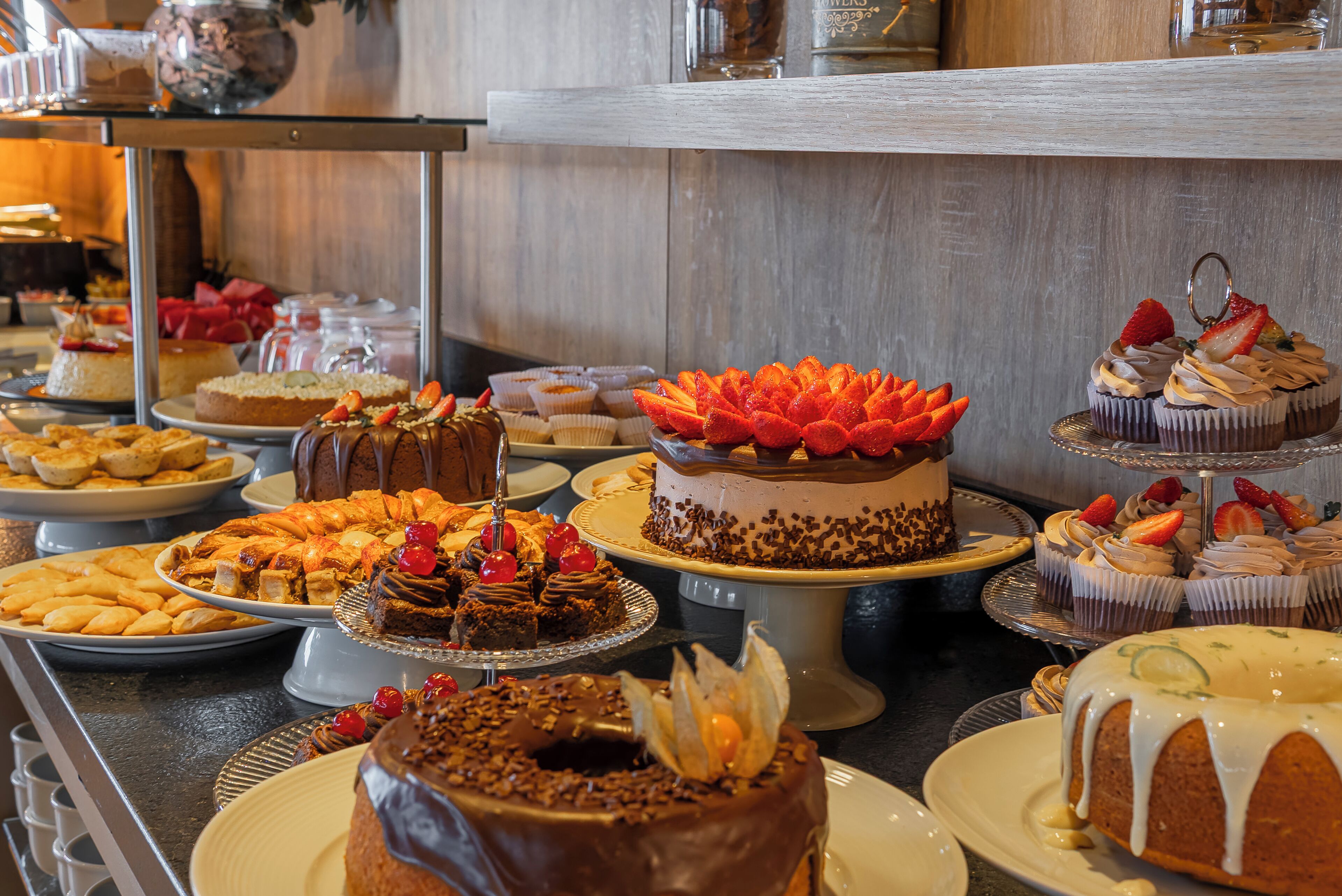 A variety of desserts on display, including cakes, cupcakes, and pastries.
